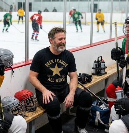 Black Hockey t-shirt with a star, crossed hockey stick logo and text-Beer League All Star in gold