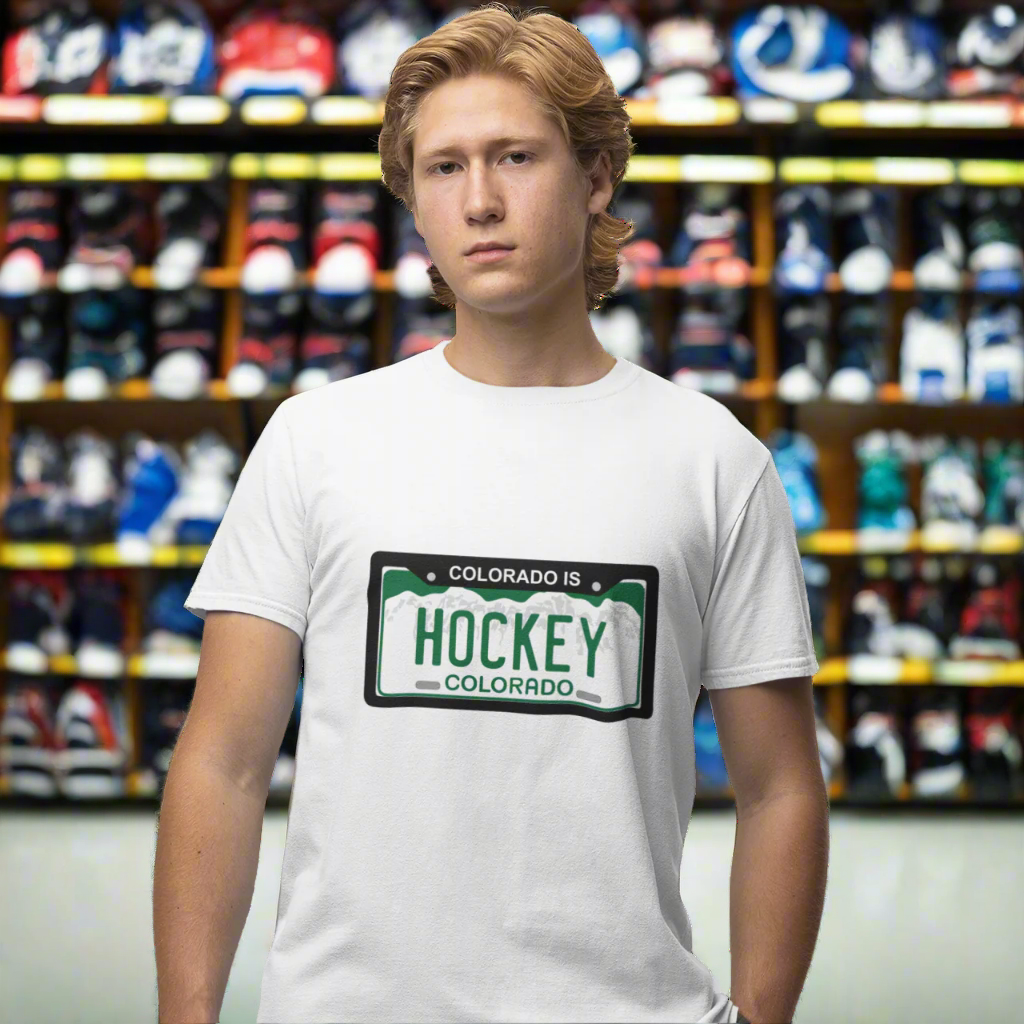 Person wearing a white t-shirt with a graphic design "Colorado IS Hockey" on a white background