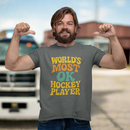 Man wearing a gray t-shirt with "World's Most OK Hockey Player" in a colorful, funky font