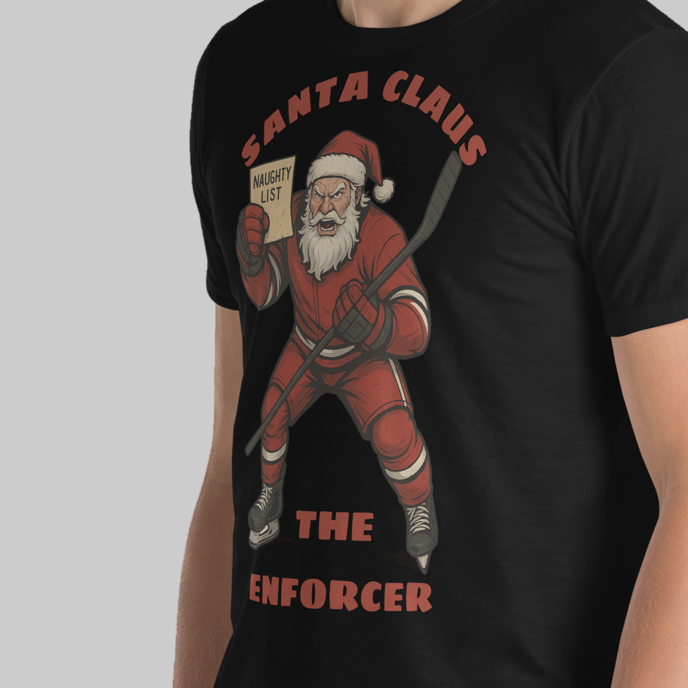 Black t-shirt with a graphic of Santa Claus holding a hockey stick and 'Naughty List' paper, labeled 'The Enforcer'.
