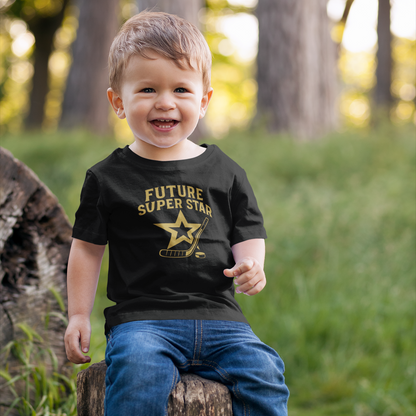 Little boy showing off his “Future Super Star” shirt while sitting with dad wearing “Beer League All Star.”