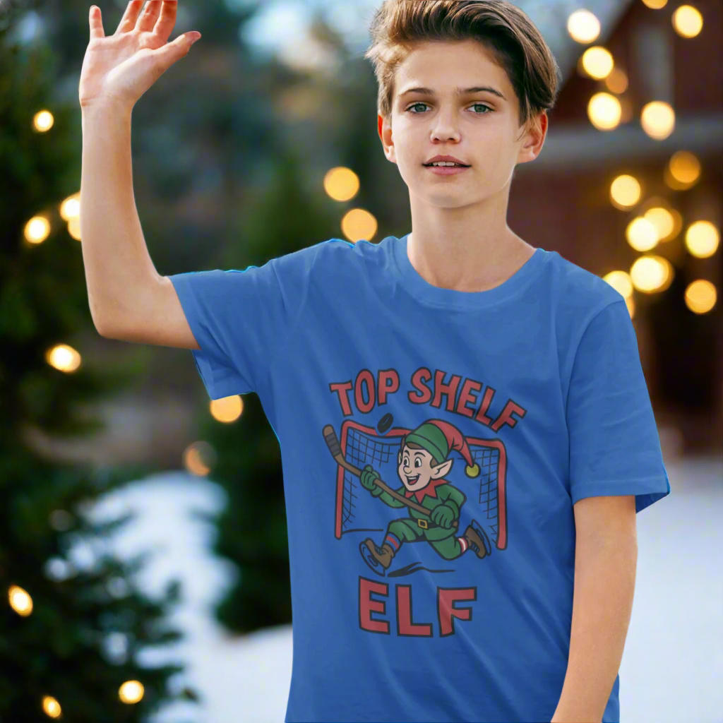 Boy wearing a royal blue shirt with the the Top Shelf Elf scoring a Christmas goal