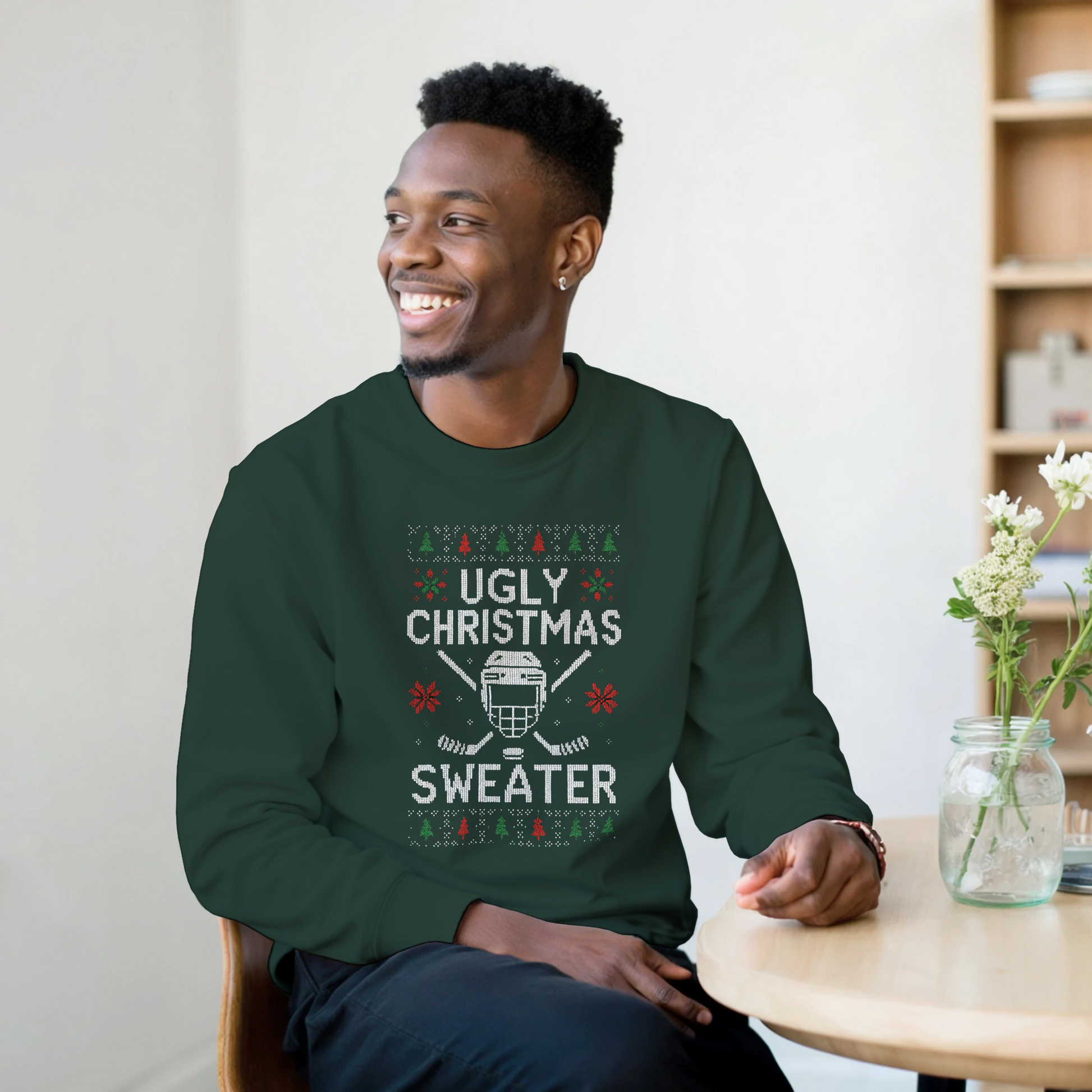 A man wearing a green Ugly Christmas Sweater with a fun hockey theme with poinsettia and Christmas trees