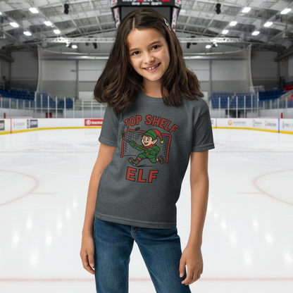 Girl wearing a 'Top Shelf Elf' t-shirt on a white background