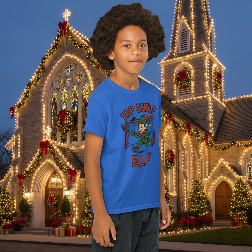 Child wearing a blue t-shirt with a 'Top Shelf Elf' graphic 